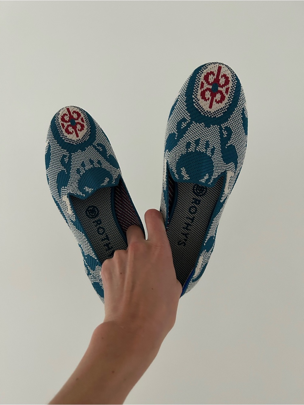 Rothy's Teal and White Patterned Slip-On Flats with Red Medallion